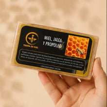 Cargar imagen en el visor de la galería, Jabón de miel y propóleo para imperfecciones en mano, con diseño atractivo y colorido, resaltando sus ingredientes naturales.